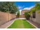 Private backyard featuring lush green grass area, desert landscaping, and mature trees creating a tranquil outdoor retreat at 6085 S Wilson Dr, Chandler, AZ 85249