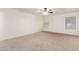 The spacious bedroom has neutral carpet, a ceiling fan, and large windows at 6085 S Wilson Dr, Chandler, AZ 85249