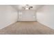 This cozy bedroom features neutral carpet, a ceiling fan, and two sunny windows at 6085 S Wilson Dr, Chandler, AZ 85249