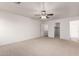 The spacious bedroom includes neutral carpet, a ceiling fan, a closet and attached bathroom at 6085 S Wilson Dr, Chandler, AZ 85249