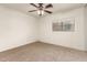 The spacious bedroom has neutral carpet, a ceiling fan and a sunny window at 6085 S Wilson Dr, Chandler, AZ 85249