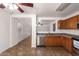 The kitchen features stainless steel appliances, wood cabinetry, and tile floors at 6085 S Wilson Dr, Chandler, AZ 85249