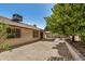 Spacious backyard with desert landscaping, a covered patio, and exterior of the home at 6602 W Ironwood Dr, Glendale, AZ 85302