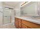 Bathroom features a shower, a double sink vanity, and tile flooring at 6602 W Ironwood Dr, Glendale, AZ 85302