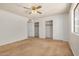 Bedroom with neutral carpet, closet, ceiling fan and large windows at 6602 W Ironwood Dr, Glendale, AZ 85302