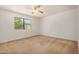 Bedroom featuring neutral carpet, ceiling fan, and natural lighting at 6602 W Ironwood Dr, Glendale, AZ 85302