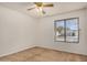 This bedroom features neutral walls, carpet, a window, and a ceiling fan at 6602 W Ironwood Dr, Glendale, AZ 85302