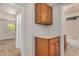 Hallway with a cabinet featuring a counter and drawers, leading to a full bathroom at 6602 W Ironwood Dr, Glendale, AZ 85302