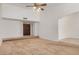 Spacious living room with carpet flooring, vaulted ceilings and a classic ceiling fan at 6602 W Ironwood Dr, Glendale, AZ 85302