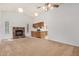 Cozy living room featuring a brick fireplace and open access to the kitchen at 6602 W Ironwood Dr, Glendale, AZ 85302