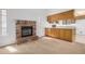 Cozy living room featuring a brick fireplace and a kitchen breakfast bar at 6602 W Ironwood Dr, Glendale, AZ 85302