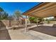 The covered patio offers an open ceiling, concrete floor and views of the yard at 6602 W Ironwood Dr, Glendale, AZ 85302