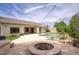 Backyard with a lagoon pool, lush landscaping, outdoor kitchen, and a covered patio at 7214 E Rustling Pass, Scottsdale, AZ 85255