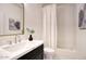 Bright bathroom featuring white subway tiles, a white shower curtain, and a marble countertop at 7214 E Rustling Pass, Scottsdale, AZ 85255