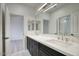 Bathroom featuring a double vanity with stone counters and modern fixtures at 7214 E Rustling Pass, Scottsdale, AZ 85255
