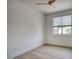 A bright bedroom features wood-look flooring and a ceiling fan at 7214 E Rustling Pass, Scottsdale, AZ 85255