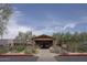A community clubhouse featuring a welcoming entrance, stone accents, and lush landscaping at 7214 E Rustling Pass, Scottsdale, AZ 85255