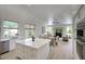 Open kitchen featuring a large island, stainless steel appliances, and a seamless transition to the dining and living areas at 7214 E Rustling Pass, Scottsdale, AZ 85255