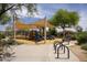 Community playground with shade sails, climbing structures, and benches at 7214 E Rustling Pass, Scottsdale, AZ 85255