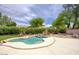 Beautiful backyard showcasing a lagoon pool, lush landscaping, and a fire pit area at 7214 E Rustling Pass, Scottsdale, AZ 85255