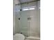Modern tiled shower with glass door and pebble floor at 7214 E Rustling Pass, Scottsdale, AZ 85255