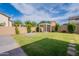 Spacious backyard showcases a well-manicured lawn and a charming pergola, perfect for outdoor relaxation at 809 W Coles Rd, Phoenix, AZ 85041