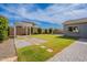 Landscaped backyard with fresh grass, a stone walkway, and a pergola structure perfect for outdoor gatherings at 809 W Coles Rd, Phoenix, AZ 85041