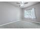 Comfortable bedroom with neutral carpet, a ceiling fan, and a window offering natural light at 809 W Coles Rd, Phoenix, AZ 85041