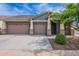 Charming single-Gathering home featuring a three-car garage and stone accents on the front facade at 809 W Coles Rd, Phoenix, AZ 85041