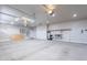 Clean garage with water softener, lighting and shelving perfect for storage and organization at 809 W Coles Rd, Phoenix, AZ 85041