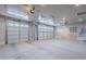Spacious three car garage with ample lighting, finished walls, and automatic door openers installed at 809 W Coles Rd, Phoenix, AZ 85041
