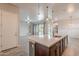 The kitchen island is the focal point of this open floor plan, complemented by modern pendant lighting at 809 W Coles Rd, Phoenix, AZ 85041