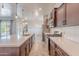 Well-lit kitchen with a large island, stainless steel appliances, and modern fixtures at 809 W Coles Rd, Phoenix, AZ 85041
