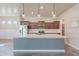 Bright kitchen features stainless steel appliances, sleek white countertops, and dark wood cabinets at 809 W Coles Rd, Phoenix, AZ 85041