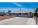 Charming single-story home featuring a blue front door, shuttered windows, and concrete driveway at 8326 N 8Th St, Phoenix, AZ 85020