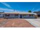 Charming single-story home featuring a blue front door, shuttered windows, and low-maintenance landscaping at 8326 N 8Th St, Phoenix, AZ 85020