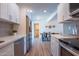 Modern kitchen with stainless steel appliances, white cabinets, and dining area in the background at 8326 N 8Th St, Phoenix, AZ 85020