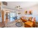 Bright living room featuring a leather sofa, ceiling fan and open floorplan to the kitchen and dining area at 8326 N 8Th St, Phoenix, AZ 85020