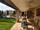 Covered patio offers outdoor seating and views of the landscaped backyard and pool at 8851 S Juniper St, Tempe, AZ 85284