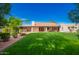 Expansive backyard with a lush lawn, mature trees, and a covered patio, perfect for outdoor activities and entertaining at 8851 S Juniper St, Tempe, AZ 85284