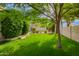 Well-maintained backyard featuring a lush lawn, mature trees, and attractive landscaping that creates a serene atmosphere at 8851 S Juniper St, Tempe, AZ 85284