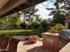 Backyard featuring a built-in barbecue area, patio with seating, and lush green lawn at 8851 S Juniper St, Tempe, AZ 85284