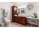Elegant bathroom featuring a wood vanity, decorative lighting and an ornate stained glass window at 8851 S Juniper St, Tempe, AZ 85284