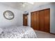 Cozy bedroom showcasing a comfortable bed, an interesting decorative mirror, and a closet with sliding doors at 8851 S Juniper St, Tempe, AZ 85284