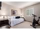 Bright, carpeted bedroom with daybed, exercise bike and window with wooden shutters at 8851 S Juniper St, Tempe, AZ 85284
