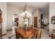 Bright dining room featuring a chandelier, large window, and detailed woodworking at 8851 S Juniper St, Tempe, AZ 85284