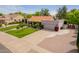 Well-maintained property features a neutral color palette, attached two-car garage, and colorful landscaping elements at 8851 S Juniper St, Tempe, AZ 85284