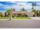 Charming single-story home with a well-manicured lawn, mature trees, and an attached two-car garage at 8851 S Juniper St, Tempe, AZ 85284