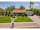 Charming single-story home with lush lawn, mature trees, and manicured landscaping creates inviting curb appeal at 8851 S Juniper St, Tempe, AZ 85284