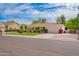 Charming single-story home with a well-manicured lawn, mature trees, and an attached two-car garage at 8851 S Juniper St, Tempe, AZ 85284